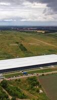 Aerial panoramic view on innovative plant in nature. Modern factory building in the countryside. Aerial view. Vertical video