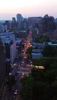 Old and new building of famous New York at sunset. Gorgeous skyscrapers switching on lights at the backdrop. Vertical video