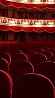 Empty classic theater. Rows of empty red velvet seats inside a theater or opera. No people in hall because of pandemic. Selective focus on opera interior. Vertical video