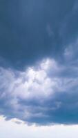 Cloud mass moving around the sky. Dark clouds spreading in the sky. Timelapse low angle view perspective. Vertical video
