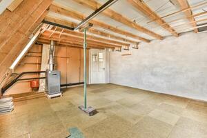 An empty room with a ceiling fan and a heater photo