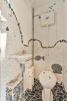 A bathroom with a toilet and sink photo