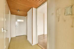 A hallway with a door and a light switch photo