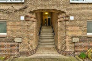 A brick building with a stairway leading up to it photo