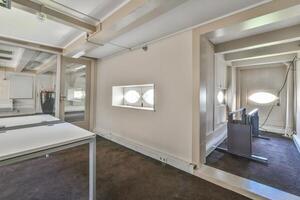 A room with a desk and a mirror in it photo