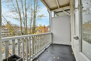 A balcony with a view of trees and buildings photo