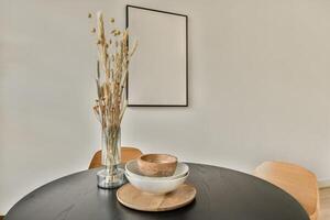 A black table with a bowl of dry grass on it photo