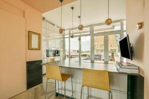A kitchen with a counter and a tv above it photo