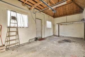 An empty garage with a ladder and ladder photo