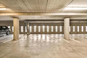 An empty parking garage with a car parked in it photo
