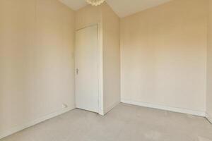 An empty room with a door and a ceiling fan photo