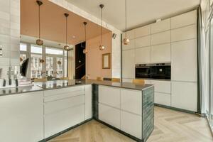 A kitchen with a large island and a window photo