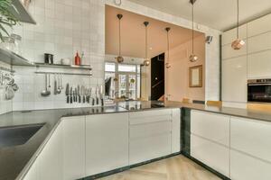 A kitchen with a sink, stove and counter top photo