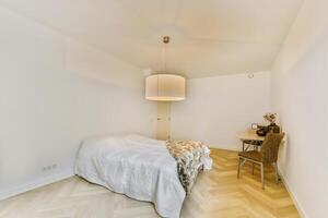 A bedroom with a bed and a chair in it photo