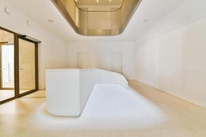 A white room with a curved wall and a staircase photo