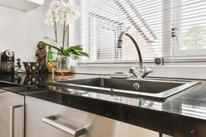 A kitchen with a sink and a window photo
