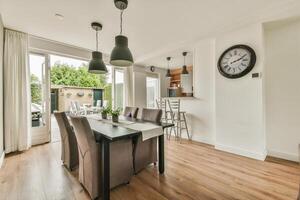 A dining room with a table and chairs photo