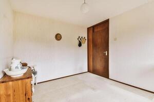 A room with a door and a table and a chair photo