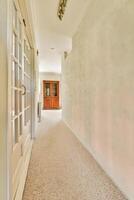 A hallway with a door and a window photo