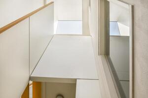 A view of a stairway and a window in a white house photo