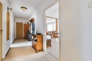 A hallway with a door and a table photo