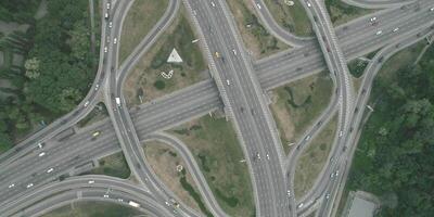 Large transport interchange on highway. Top view of traffic on roundabout, Intense traffic on highway on big junction with bridges and tunnels video