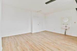 An empty room with a sink and toilet in it photo
