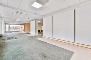 An empty office with white walls and carpet photo