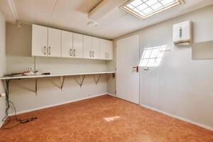 A room with a sink and cabinets in it photo