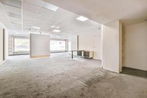 An empty office with a large window and a door photo