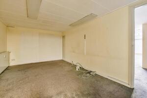 An empty room with a door and a window photo
