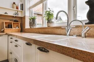 A kitchen with a sink and a window photo