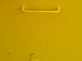 Yellow painted steel texture for a close-up background of a building or construction. photo