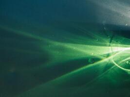 Green light reflecting in the dark for an abstract, mysterious or magical background. photo