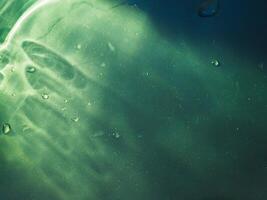 Green light reflecting in the dark for an abstract, mysterious or magical background. photo