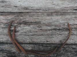 Brown dry pine leaves on old wood for a retro style background. photo