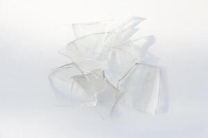 Broken glass or sharp shards of glass on a white background photo