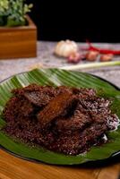 Beef Rendang is a Minang dish originating from the Minangkabau region in West Sumatra, Indonesia. Rendang has been slow cooked and braised in a coconut milk seasoned with a herb and spice mixture photo