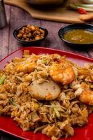 Kwetiau goreng medan or char kway teow It is made from noodles, which are stir fried in cooking oil with garlic, onion or shallots, pork, fried prawn, sliced bakso photo