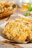 Pisang goreng Coklat Keju is a fritter made by deep frying battered plantain in hot oil. The batter most commonly uses a combination of flour, either wheat, rice flour, tapioca or bread crumb. photo