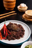Beef Rendang is a Minang dish originating from the Minangkabau region in West Sumatra, Indonesia. Rendang has been slow cooked and braised in a coconut milk seasoned with a herb and spice mixture photo