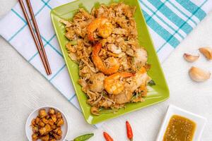 Kwetiau goreng medan or char kway teow It is made from noodles, which are stir fried in cooking oil with garlic, onion or shallots, pork, fried prawn, sliced bakso photo