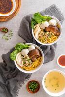 Bak chor mee. The noodles are tossed in vinegar, minced meat, pork slices, pork liver, stewed sliced mushrooms, meat balls and bits of deep-fried lard photo