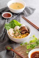 Bak chor mee. The noodles are tossed in vinegar, minced meat, pork slices, pork liver, stewed sliced mushrooms, meat balls and bits of deep-fried lard photo