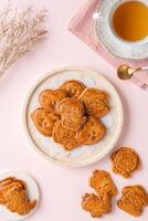 Mooncake biscuits are little sweet snacks which are like the outer layer of the mooncake. Unlike the traditional baked mooncakes, these biscuits are usually made without filling and are much thicker. photo