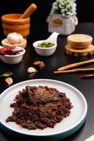 Beef Rendang is a Minang dish originating from the Minangkabau region in West Sumatra, Indonesia. Rendang has been slow cooked and braised in a coconut milk seasoned with a herb and spice mixture photo