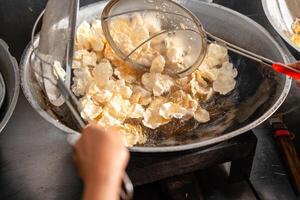 making process Emping Balado, Spicy Snacks from West Sumatra. Made from melinjo crackers, it's crunchy and sweet and spicy. photo