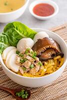 Bak chor mee. The noodles are tossed in vinegar, minced meat, pork slices, pork liver, stewed sliced mushrooms, meat balls and bits of deep-fried lard photo