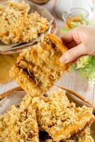Pisang goreng Coklat Keju is a fritter made by deep frying battered plantain in hot oil. The batter most commonly uses a combination of flour, either wheat, rice flour, tapioca or bread crumb. photo