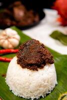 Beef Rendang is a Minang dish originating from the Minangkabau region in West Sumatra, Indonesia. Rendang has been slow cooked and braised in a coconut milk seasoned with a herb and spice mixture photo